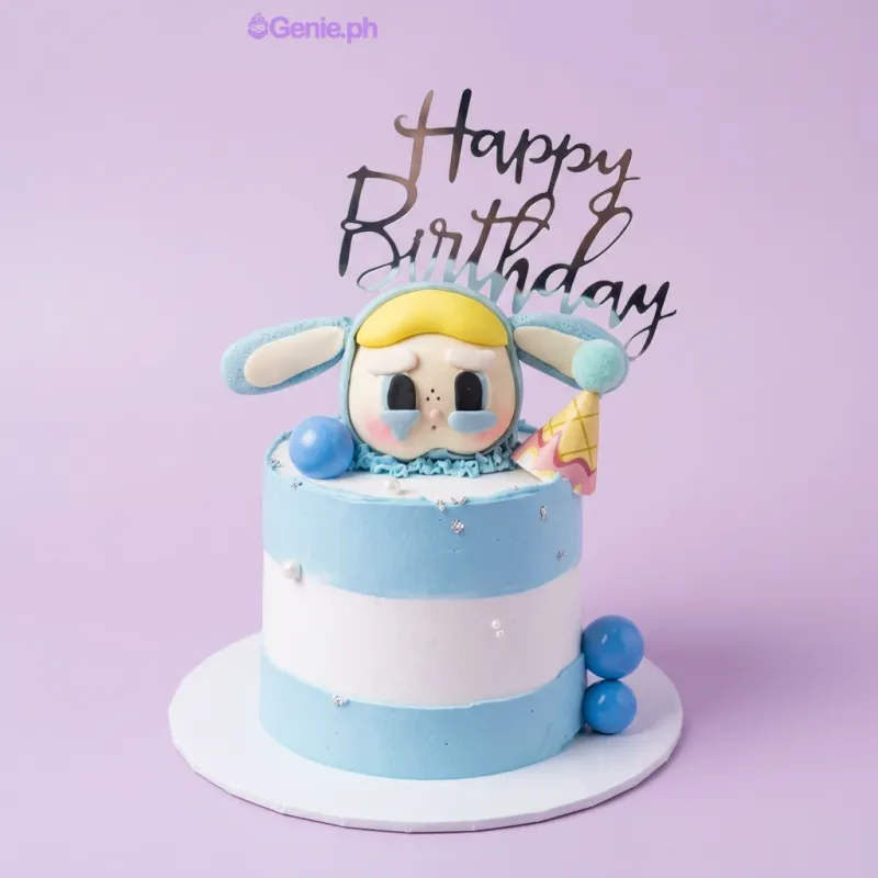 Light blue and white 1-tier cake with a 3D fondant character topper wearing a party hat and a silver Happy Birthday cardstock topper Light blue and white 1-tier cake with a 3D fondant character topper wearing a party hat and a silver Happy Birthday cardstock topper