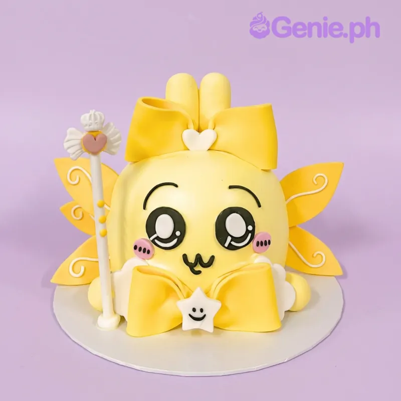 Yellow character cake with a large bow, wand, and star topper Yellow character cake with a large bow, wand, and star topper