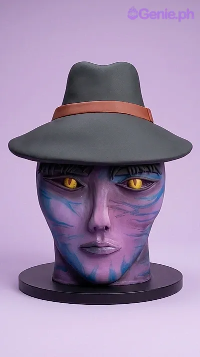 A purple and black 1 Tier Fondant cake, character face themed, featuring yellow eyes and a black hat with a red band. A purple and black 1 Tier Fondant cake, character face themed, featuring yellow eyes and a black hat with a red band.