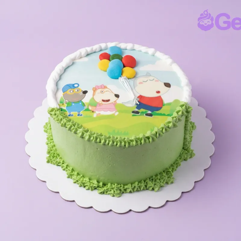 A green and blue 1 Tier cake themed around a Character Scene, featuring a printed scene with wolf, dog, and mouse characters and colorful balloons. A green and blue 1 Tier cake themed around a Character Scene, featuring a printed scene with wolf, dog, and mouse characters and colorful balloons.