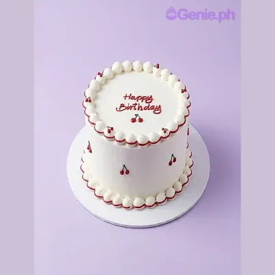 White 1-tier birthday cake with red piped cherry decorations and Happy Birthday message White 1-tier birthday cake with red piped cherry decorations and Happy Birthday message