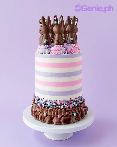 A pink and lavender 1 Tier cake themed around Chocolate Bunny, featuring chocolate bunny figures and colorful sprinkles. A pink and lavender 1 Tier cake themed around Chocolate Bunny, featuring chocolate bunny figures and colorful sprinkles.