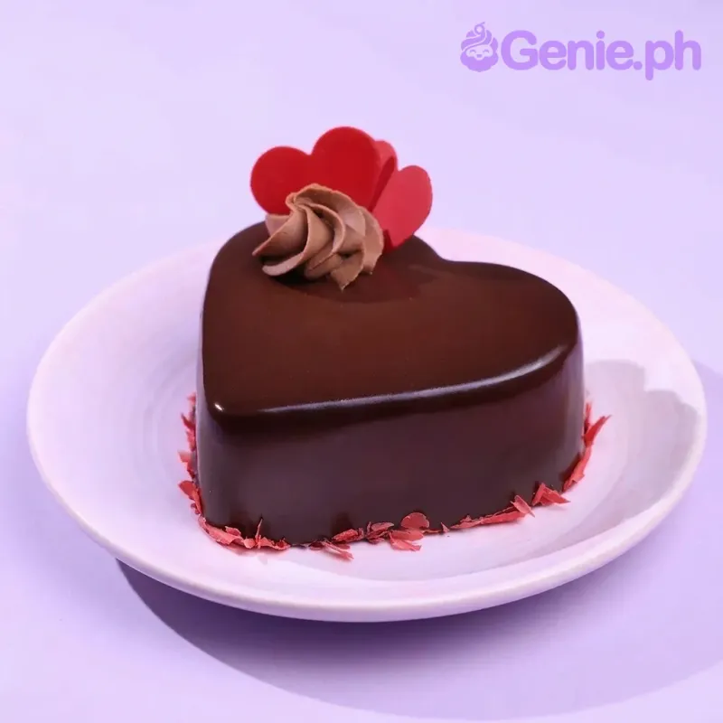 A brown 1-tier heart-shaped cake, themed Chocolate Heart, featuring red heart toppers and a chocolate swirl. A brown 1-tier heart-shaped cake, themed Chocolate Heart, featuring red heart toppers and a chocolate swirl.
