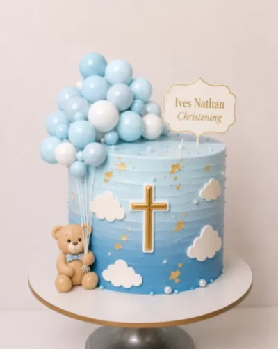 Light blue gradient 1-tier cake with a teddy bear topper, balloon cluster, gold cross, and white clouds Light blue gradient 1-tier cake with a teddy bear topper, balloon cluster, gold cross, and white clouds