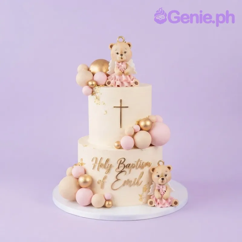 Ivory two tier Christening cake with teddy bear figurines, gold spheres, and a name topper Ivory two tier Christening cake with teddy bear figurines, gold spheres, and a name topper