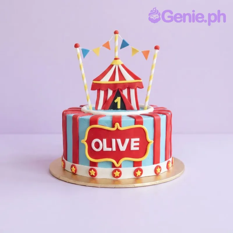 Light blue 1-tier birthday cake with a circus tent topper, red vertical stripes, and a personalized name plaque Light blue 1-tier birthday cake with a circus tent topper, red vertical stripes, and a personalized name plaque