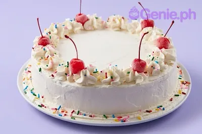 A white 1-tier round cake themed around Classic Cherry, featuring red cherries with stems and whipped icing swirls with rainbow sprinkles. A white 1-tier round cake themed around Classic Cherry, featuring red cherries with stems and whipped icing swirls with rainbow sprinkles.