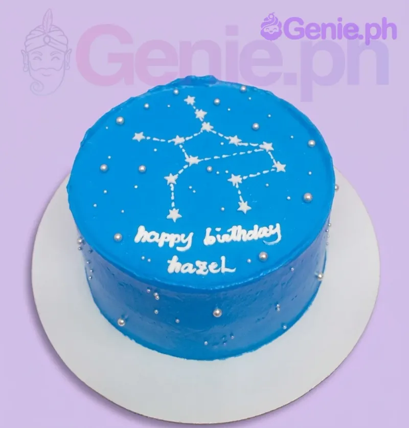 A blue and white 1-tier cake themed around constellations, featuring a piped white constellation design, silver dragees, and 'happy birthday hazel' text. A blue and white 1-tier cake themed around constellations, featuring a piped white constellation design, silver dragees, and 'happy birthday hazel' text.