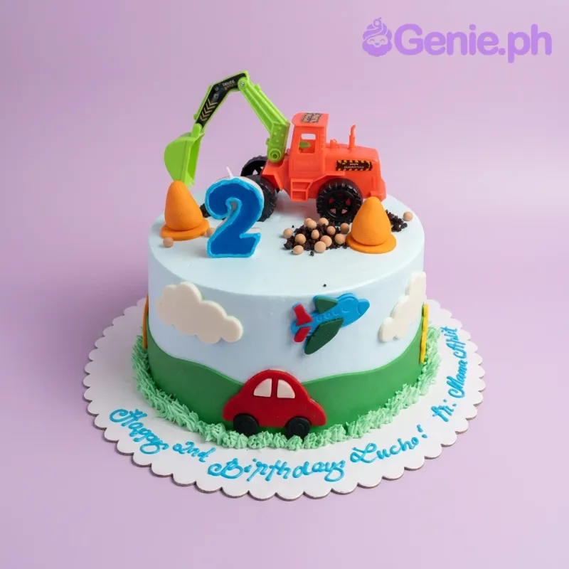 Construction themed birthday cake with a large orange excavator toy, orange cones, and a blue number 2 candle on light blue icing. Construction themed birthday cake with a large orange excavator toy, orange cones, and a blue number 2 candle on light blue icing.
