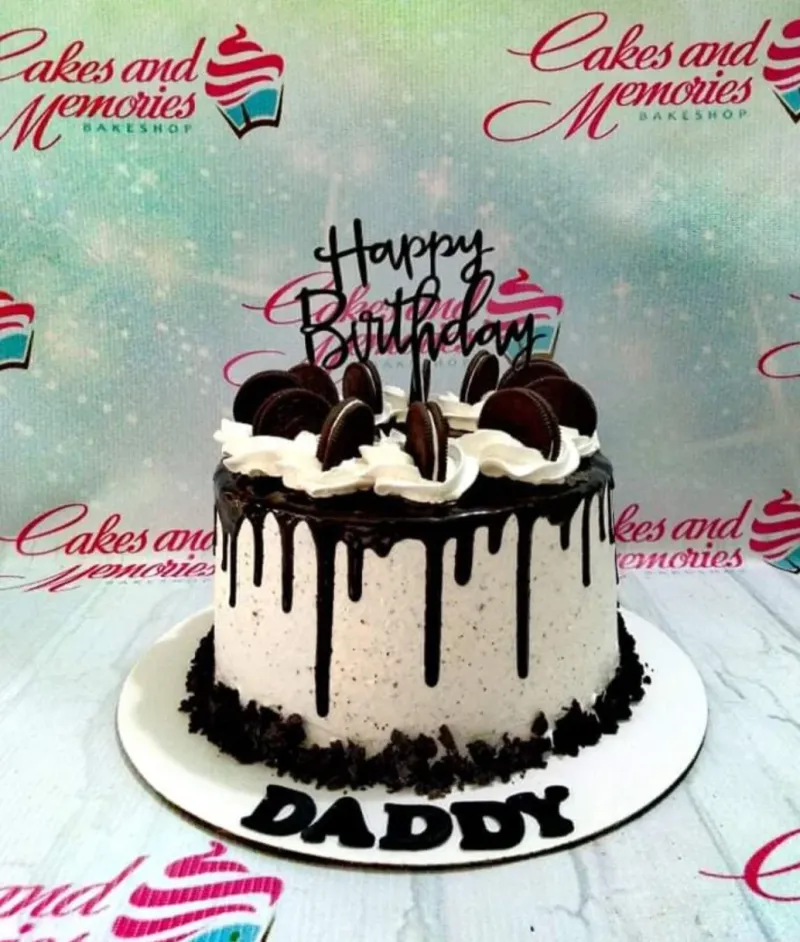 Cookies and cream birthday cake with chocolate drip, Oreo cookies, and a black Happy Birthday topper. Cookies and cream birthday cake with chocolate drip, Oreo cookies, and a black Happy Birthday topper.
