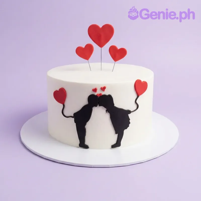 A white 1 Tier cake themed around Couple Silhouette, with red heart toppers and a black kissing couple silhouette. A white 1 Tier cake themed around Couple Silhouette, with red heart toppers and a black kissing couple silhouette.