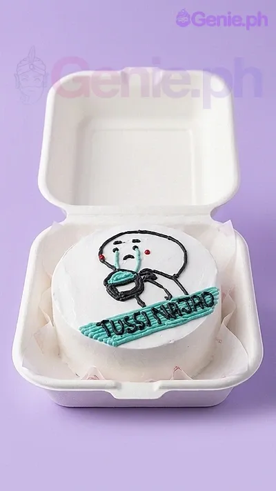 A white bento cake themed around a crying character, featuring a hand-drawn crying character holding a cup and 'TUSSI NA JAO' text on a teal border. A white bento cake themed around a crying character, featuring a hand-drawn crying character holding a cup and 'TUSSI NA JAO' text on a teal border.