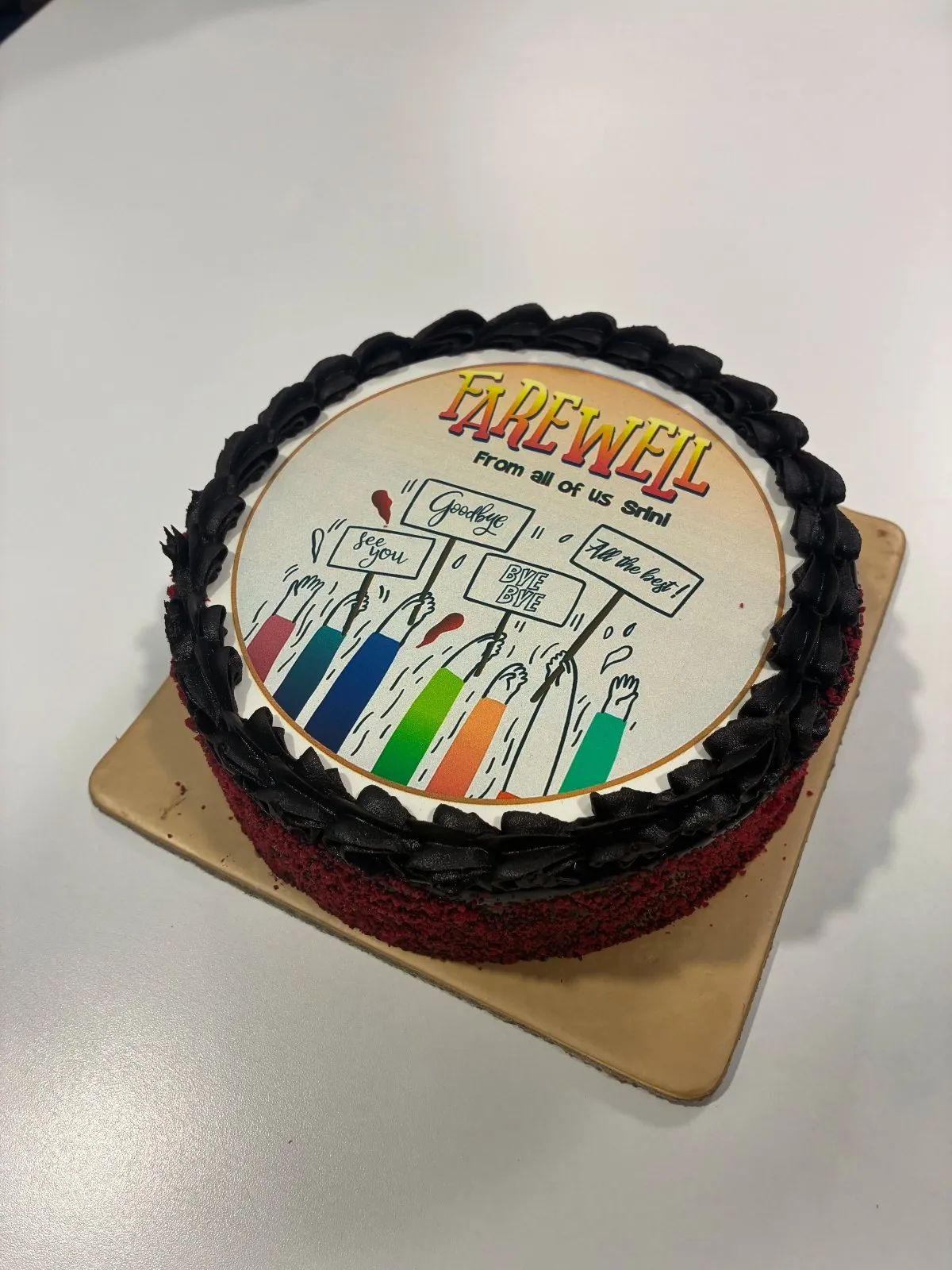 One tier white cake with a circular farewell printout and black piped border One tier white cake with a circular farewell printout and black piped border