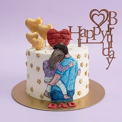 White single tier cake with a printout of a father and daughter hugging and gold heart toppers White single tier cake with a printout of a father and daughter hugging and gold heart toppers
