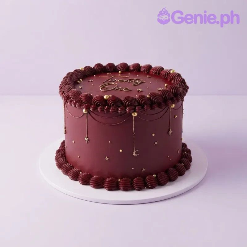 Dark red 1-tier cake with smooth soft icing, piped borders, gold edible pearls, and gold star and moon accents Dark red 1-tier cake with smooth soft icing, piped borders, gold edible pearls, and gold star and moon accents