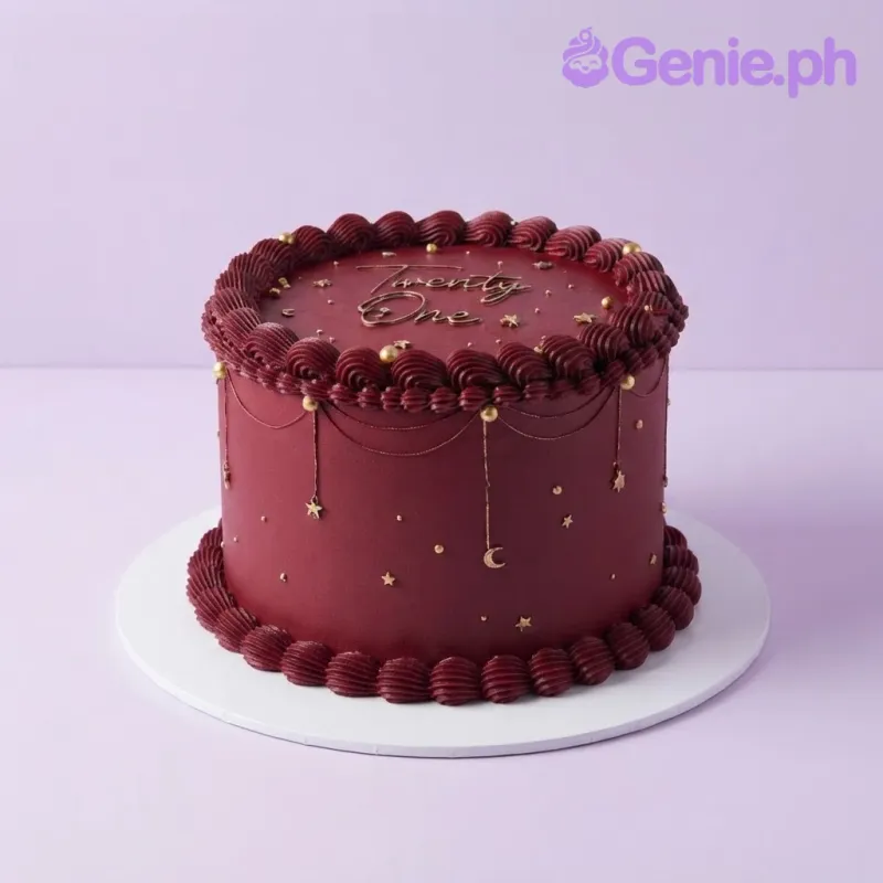 Dark red 1-tier cake with smooth soft icing, piped borders, gold star accents, and a Twenty One text topper Dark red 1-tier cake with smooth soft icing, piped borders, gold star accents, and a Twenty One text topper