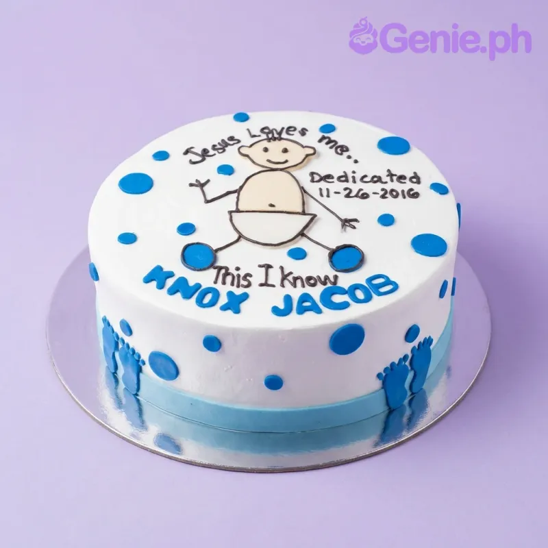 White round cake with blue polka dots and a hand-drawn baby illustration for a dedication ceremony. White round cake with blue polka dots and a hand-drawn baby illustration for a dedication ceremony.
