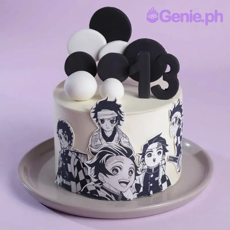 A white 1 tier cake featuring a black number 13, character cutouts of Tanjiro Kamado, black circular discs, and white fondant discs and spheres. A white 1 tier cake featuring a black number 13, character cutouts of Tanjiro Kamado, black circular discs, and white fondant discs and spheres.