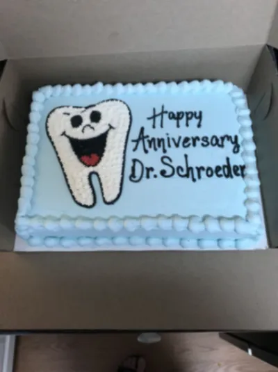 Light blue rectangle cake with smooth soft icing, a molded tooth topper, and piped shell borders Light blue rectangle cake with smooth soft icing, a molded tooth topper, and piped shell borders