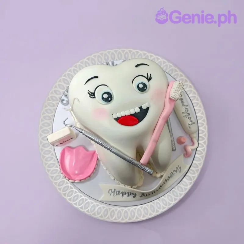 White tooth shaped fondant cake with a smiling face and dental tool decorations White tooth shaped fondant cake with a smiling face and dental tool decorations