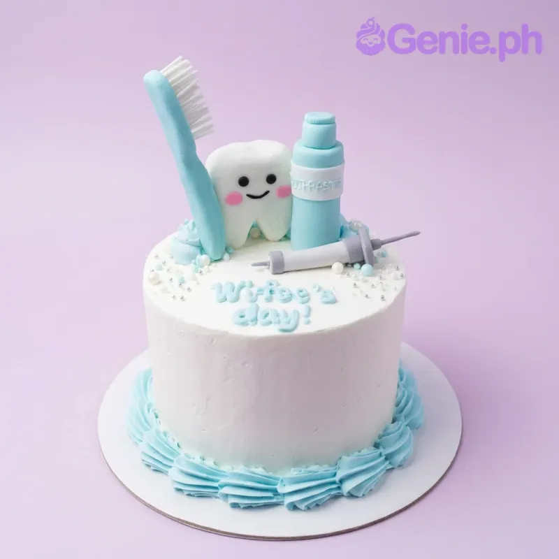 A white 1 Tier cake featuring fondant toothbrush, toothpaste, tooth, syringe, light blue icing swirls, piped border and white and silver sprinkles. A white 1 Tier cake featuring fondant toothbrush, toothpaste, tooth, syringe, light blue icing swirls, piped border and white and silver sprinkles.