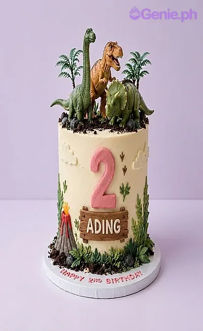Ivory 1-tier cake with soft icing, dinosaur toy toppers, a fondant volcano, and greenery accents Ivory 1-tier cake with soft icing, dinosaur toy toppers, a fondant volcano, and greenery accents