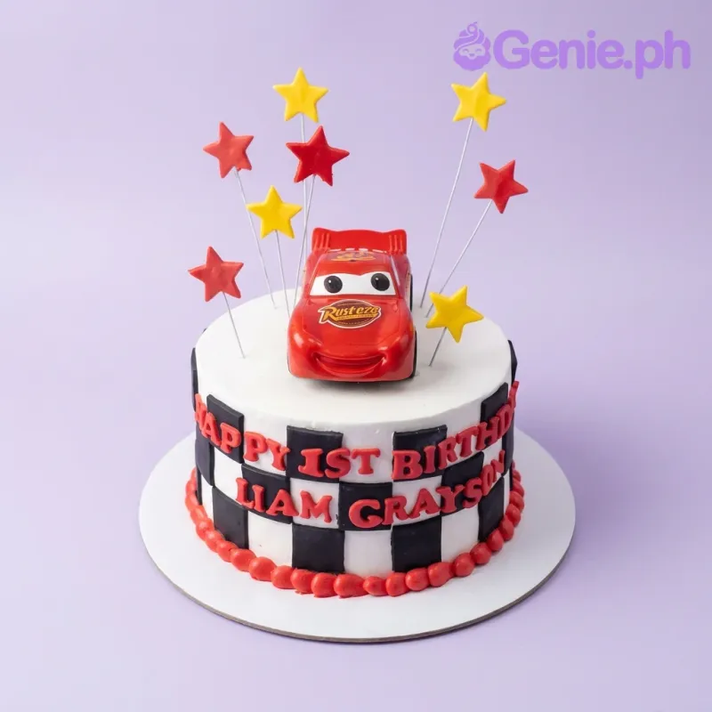 Disney Cars Lightning McQueen themed birthday cake with red and yellow stars and a black and white checkered pattern. Disney Cars Lightning McQueen themed birthday cake with red and yellow stars and a black and white checkered pattern.