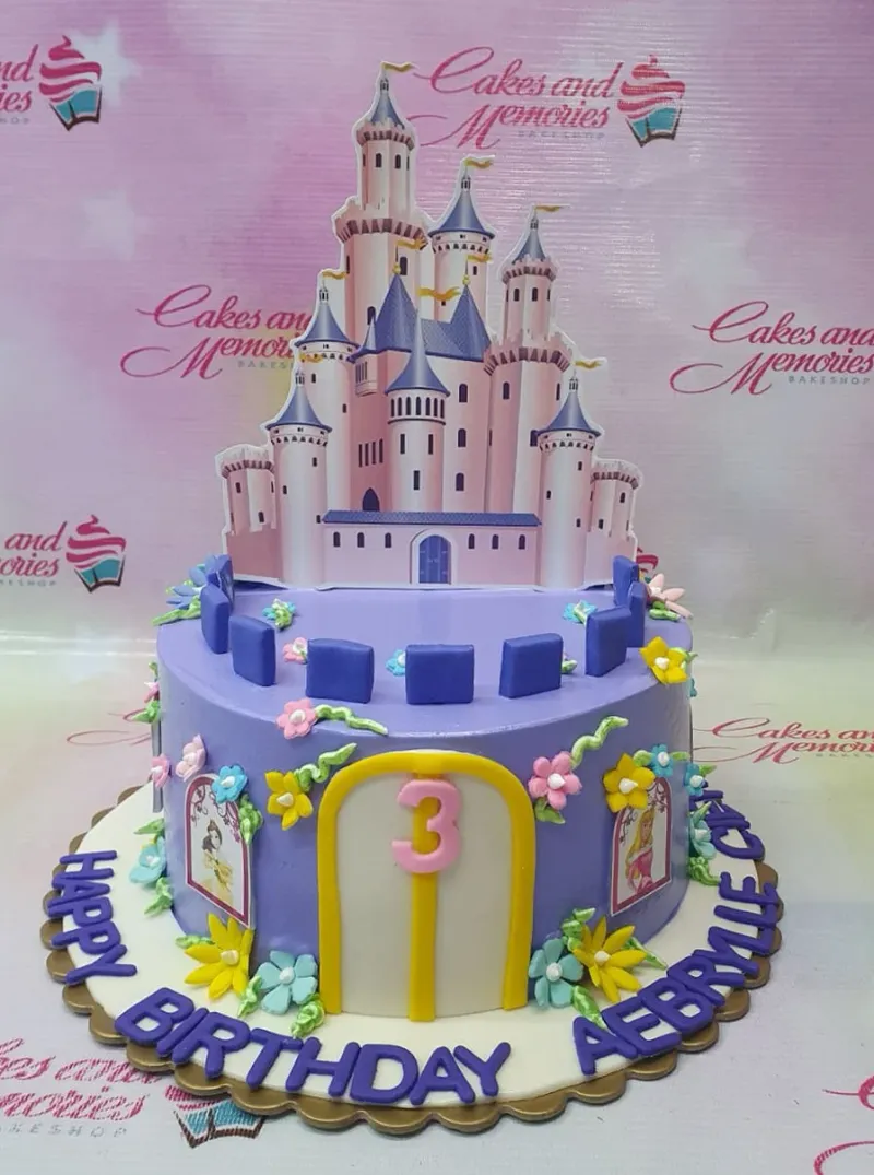 A purple 1 Tier cake themed around Disney Princess Castle, featuring a castle printout, pink number 3, and fondant flowers. A purple 1 Tier cake themed around Disney Princess Castle, featuring a castle printout, pink number 3, and fondant flowers.
