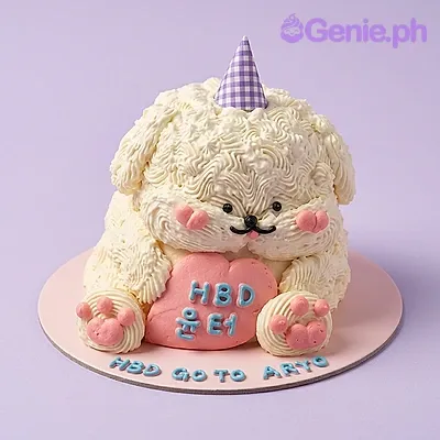 White dog-shaped cake with a party hat and a pink heart sign White dog-shaped cake with a party hat and a pink heart sign