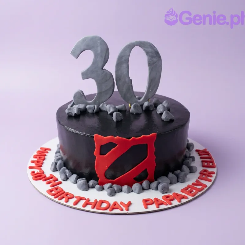 A black and grey 1-tier cake themed around Dota 2, featuring large grey number 30 toppers, a red Dota 2 logo, and grey fondant rocks. A black and grey 1-tier cake themed around Dota 2, featuring large grey number 30 toppers, a red Dota 2 logo, and grey fondant rocks.