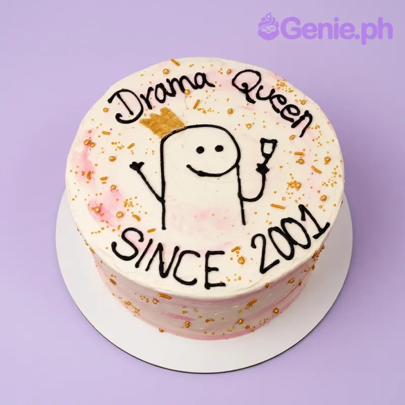 A white 1 Tier Drama Queen Flork cake, featuring a Flork character with crown and glass, pink smudges, and gold sprinkles. A white 1 Tier Drama Queen Flork cake, featuring a Flork character with crown and glass, pink smudges, and gold sprinkles.