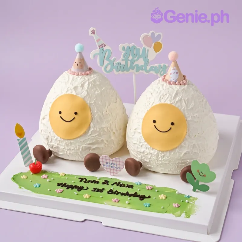 White 1-tier birthday cake with two egg-shaped cakes, party hats, and a Happy Birthday topper White 1-tier birthday cake with two egg-shaped cakes, party hats, and a Happy Birthday topper