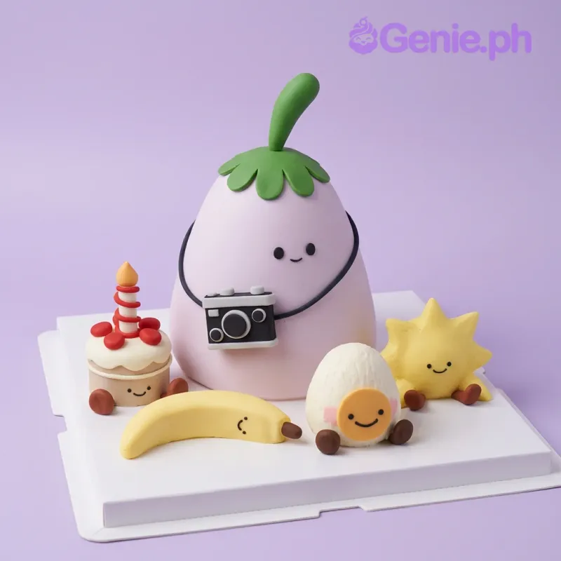 Light purple eggplant-shaped fondant cake with camera, banana, egg, and sun character toppers on a white board Light purple eggplant-shaped fondant cake with camera, banana, egg, and sun character toppers on a white board