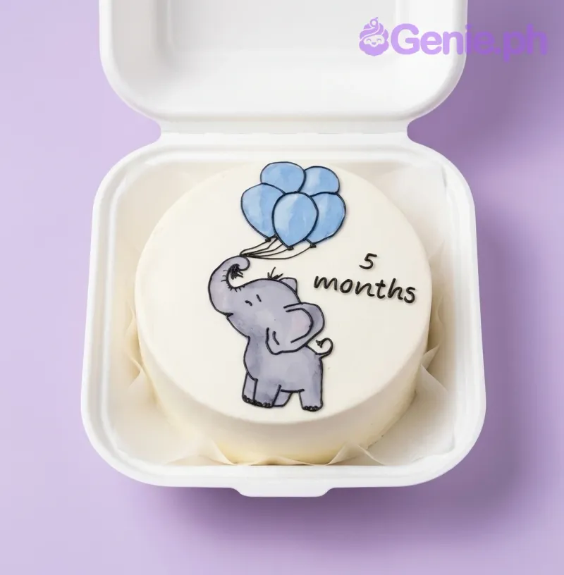 A white minimalist Bento cake themed around Elephant Milestone, featuring a hand-drawn style elephant holding blue balloons and '5 months' written in black icing. A white minimalist Bento cake themed around Elephant Milestone, featuring a hand-drawn style elephant holding blue balloons and '5 months' written in black icing.