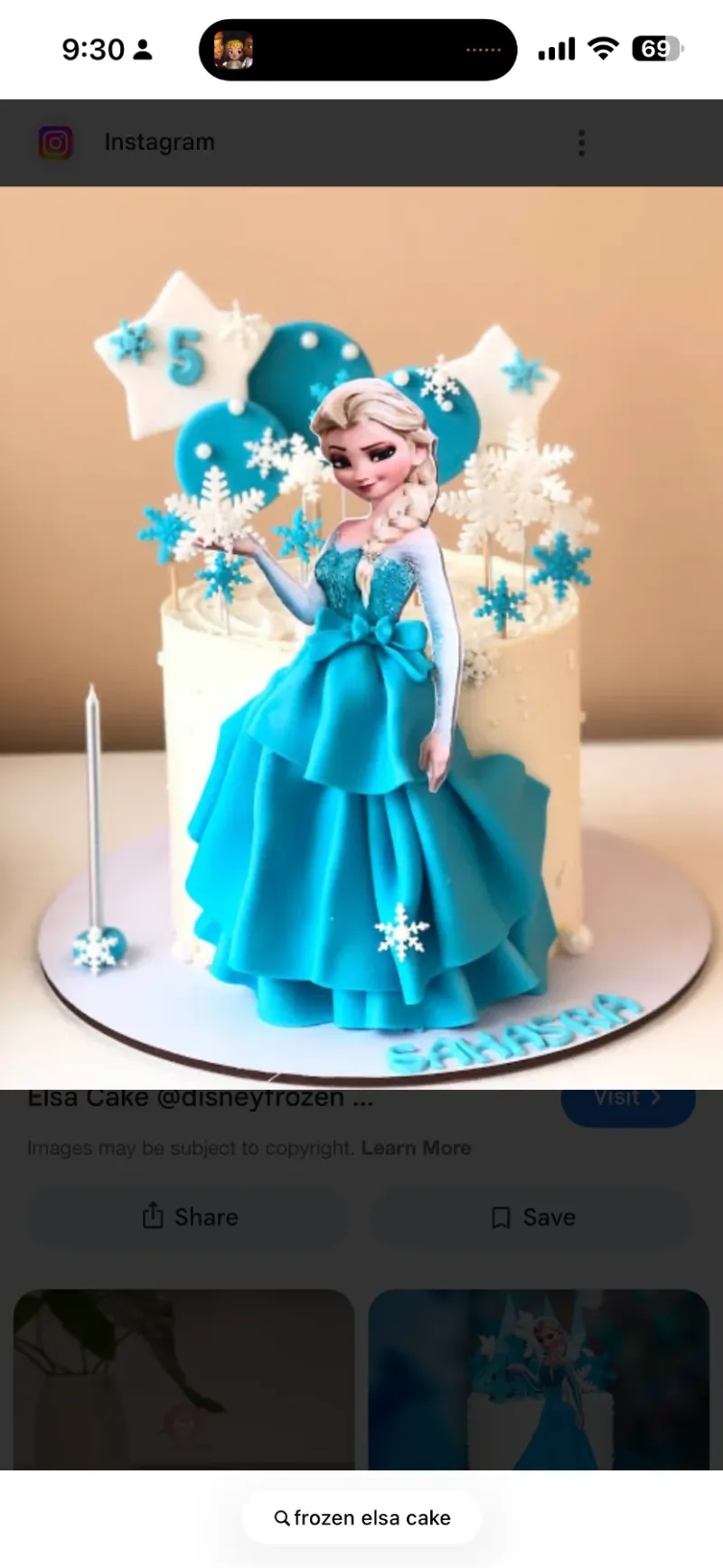 White 1-tier Elsa Frozen birthday cake with blue fondant dress, snowflake toppers, and star decorations White 1-tier Elsa Frozen birthday cake with blue fondant dress, snowflake toppers, and star decorations