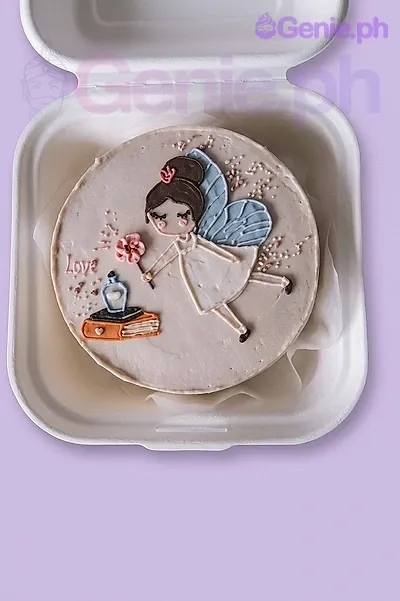 A beige Bento cake themed Fairy, featuring a hand-painted fairy, pink flower, book, and sprinkles. A beige Bento cake themed Fairy, featuring a hand-painted fairy, pink flower, book, and sprinkles.