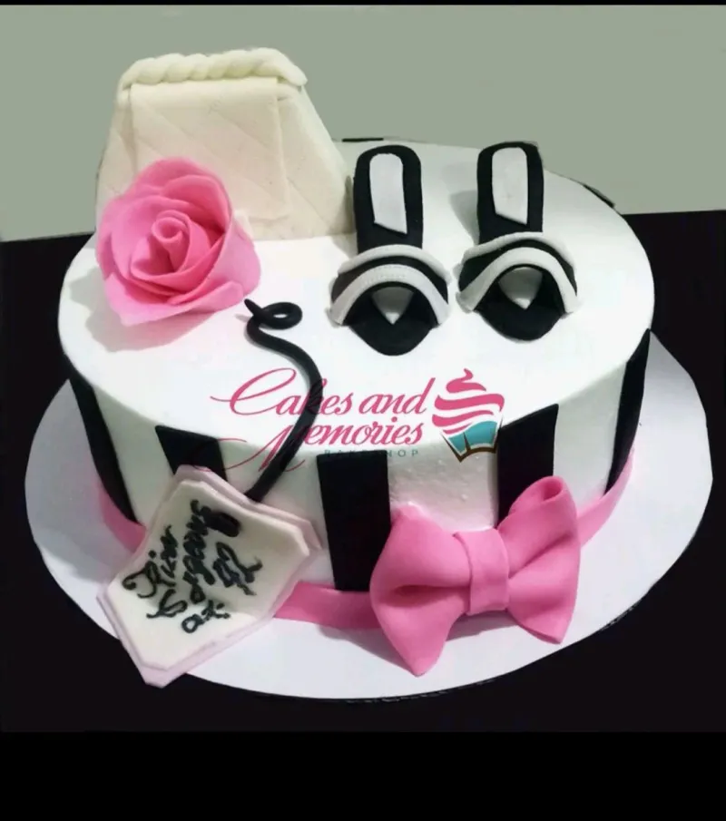 Fashion themed white fondant cake with black stripes, pink rose, high heels, and a designer handbag topper. Fashion themed white fondant cake with black stripes, pink rose, high heels, and a designer handbag topper.