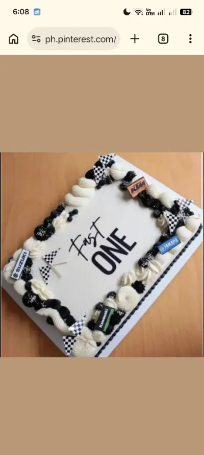White rectangle cake with smooth icing, Fast One theme, checkered racing flags, and motorcycle brand logo plaques White rectangle cake with smooth icing, Fast One theme, checkered racing flags, and motorcycle brand logo plaques