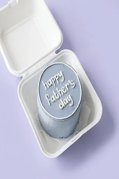 Light blue bento cake in a white clamshell box with white piped Happy Father's Day message Light blue bento cake in a white clamshell box with white piped Happy Father's Day message