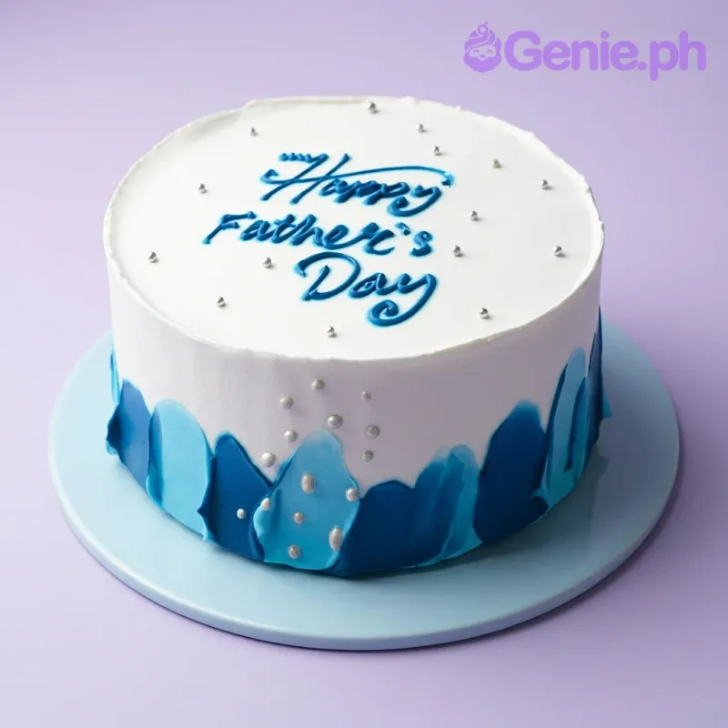 White minimalist Father's Day cake with blue palette knife icing strokes and silver dragees. White minimalist Father's Day cake with blue palette knife icing strokes and silver dragees.