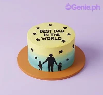A single tier cake with a yellow and light blue gradient icing, featuring black silhouettes of a father and two children and black stars. A single tier cake with a yellow and light blue gradient icing, featuring black silhouettes of a father and two children and black stars.