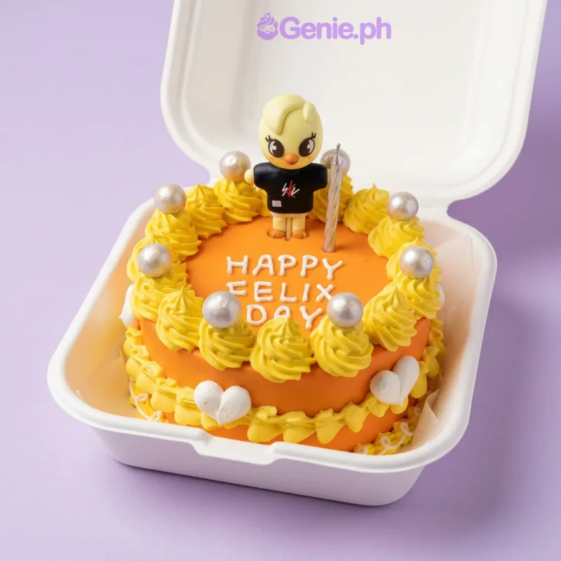 Orange 1-tier birthday cake with yellow icing rosettes, silver spheres, and a yellow bird character topper Orange 1-tier birthday cake with yellow icing rosettes, silver spheres, and a yellow bird character topper