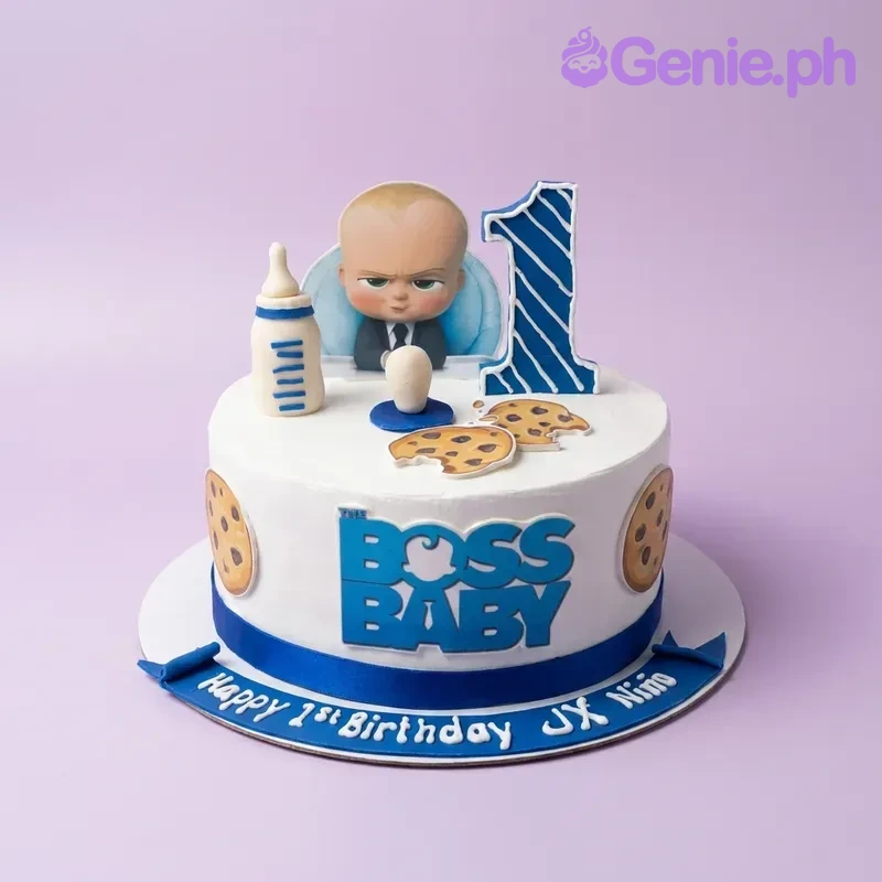 Boss Baby-Inspired White Birthday Cake Boss Baby themed 1st birthday cake with blue and white icing, fondant baby bottle, pacifier, and character toppers.