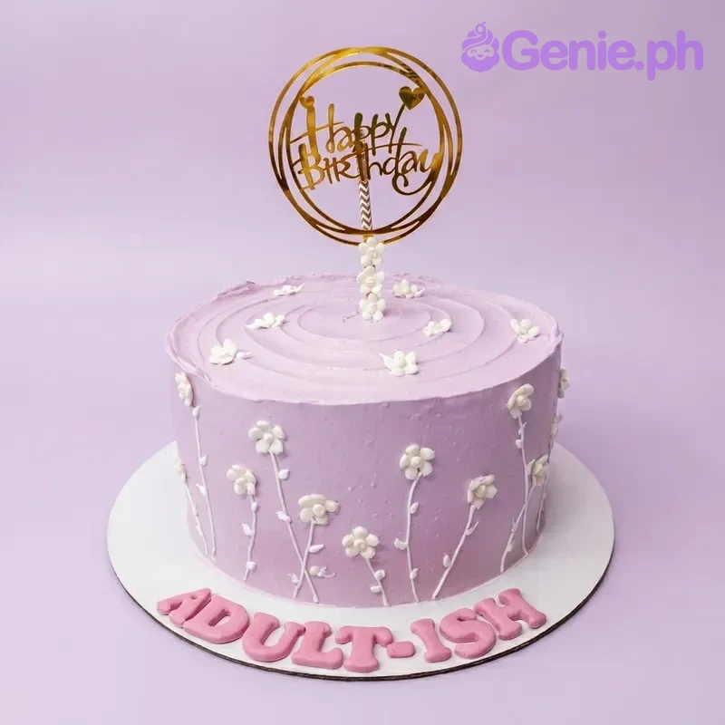 Lavender Floral Birthday Cake A lavender 1 Tier cake themed around Lavender Floral, featuring a gold Happy Birthday topper and white piped flowers.