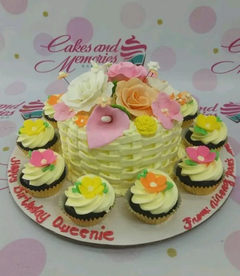 A yellow 1-tier floral basket weave cake, featuring edible gumpaste flowers, matching cupcakes, and a red message. A yellow 1-tier floral basket weave cake, featuring edible gumpaste flowers, matching cupcakes, and a red message.