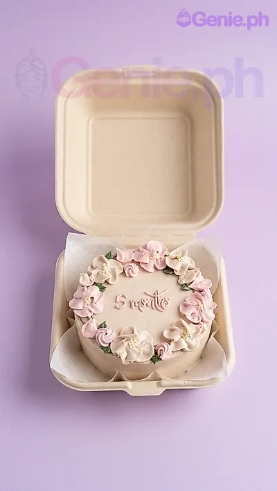 A white and ivory Bento cake with a floral theme, featuring pink and white buttercream flowers and '5 months' text. A white and ivory Bento cake with a floral theme, featuring pink and white buttercream flowers and '5 months' text.