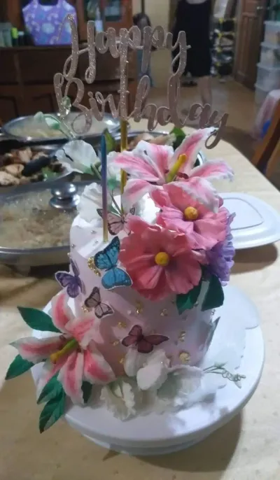 Pink 1-tier birthday cake with soft icing, large pink fondant lilies, and a rose gold glitter topper Pink 1-tier birthday cake with soft icing, large pink fondant lilies, and a rose gold glitter topper