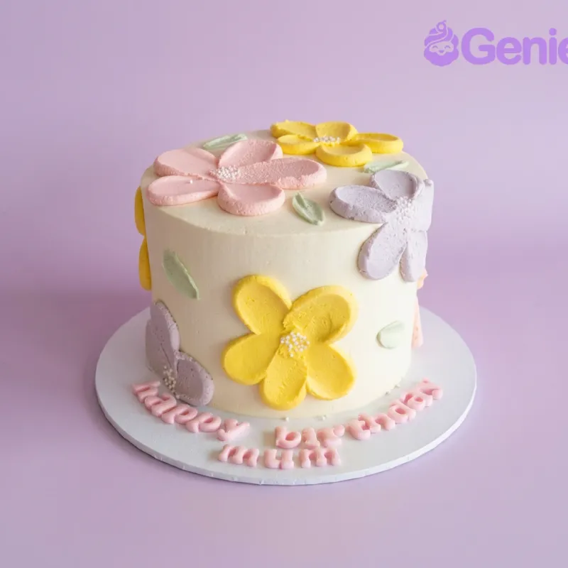 Light yellow 1-tier birthday cake with pink, yellow, and lavender palette knife flowers and green leaves Light yellow 1-tier birthday cake with pink, yellow, and lavender palette knife flowers and green leaves