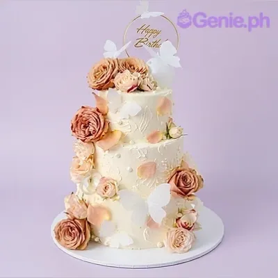White 3-tier birthday cake with white butterfly toppers and pink roses White 3-tier birthday cake with white butterfly toppers and pink roses