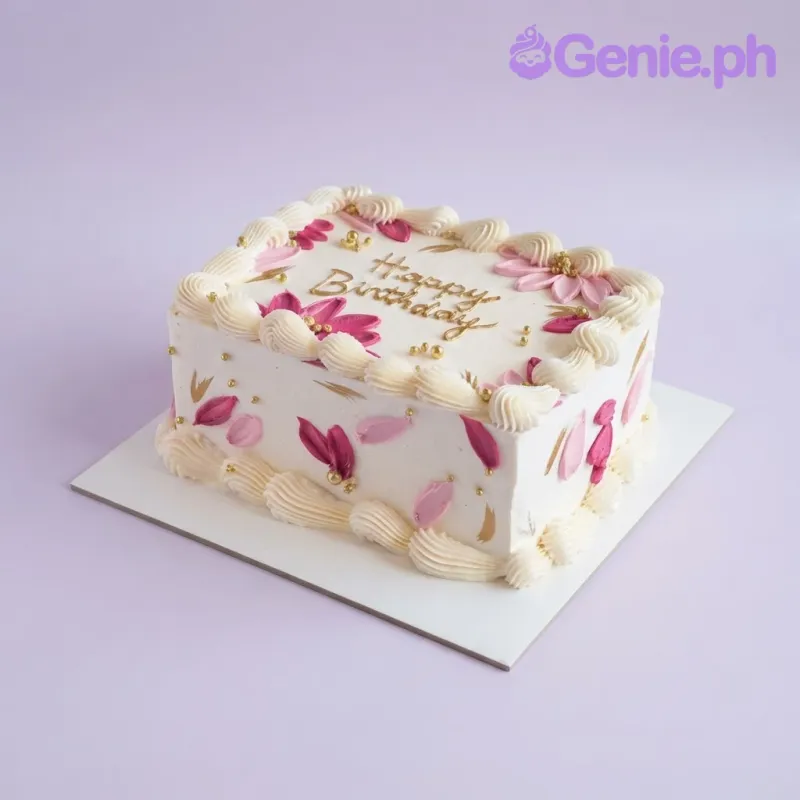 White rectangular cake with smooth soft icing, piped white borders, pink flowers, and gold lettering White rectangular cake with smooth soft icing, piped white borders, pink flowers, and gold lettering